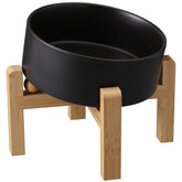 Addggo black elevated tilted bowl on bamboo stand reduces neck strain during meals.