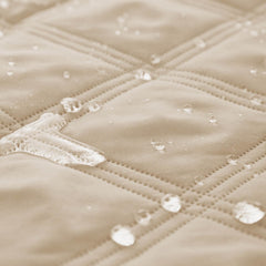 Ameritex bed cover on sofa with dog highlighting furniture protection.