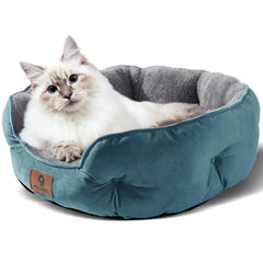 Asvin small dog bed teal side view emphasizes secure, rounded shape and neck support.