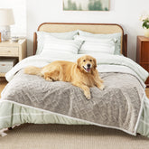 Bedsure waterproof dog blanket on bed protects linens from spills and accidents.