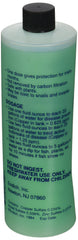 Copper Power Green bottle being poured into an aquarium, supporting parasite and fungus management.