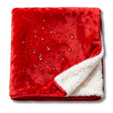 CREW FLX waterproof blanket for bed in red covers bed, protecting against spills.