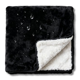 CREW FLX bed blanket demonstrates waterproof protection for spills during sleep.