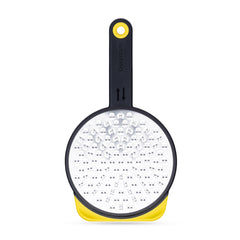 Dreamfarm Ograte bottom-side blades in motion for fast, even grating