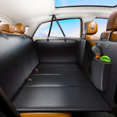 FIRSTWELL back seat extender on PU leather cover keeps dogs secure during travel.