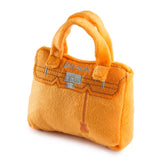 Haute Diggity Dog Barkin Bag with orange plush exterior for stylish playtime and cuddles.