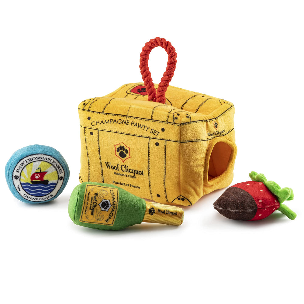 Haute Diggity Dog Woof Clicquot Pawty trunk display showcasing stylish storage for interactive toys.