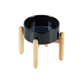 Havniva Starry Sky ceramic dog bowl on a wooden stand for elevated feeding.