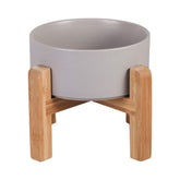 HCHLQLZ ceramic elevated cat bowl on wood stand promotes comfortable feeding posture.