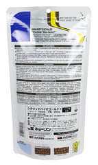 Hikari Bio-Gold pellets closeup in hand, medium-size for balanced feeding.