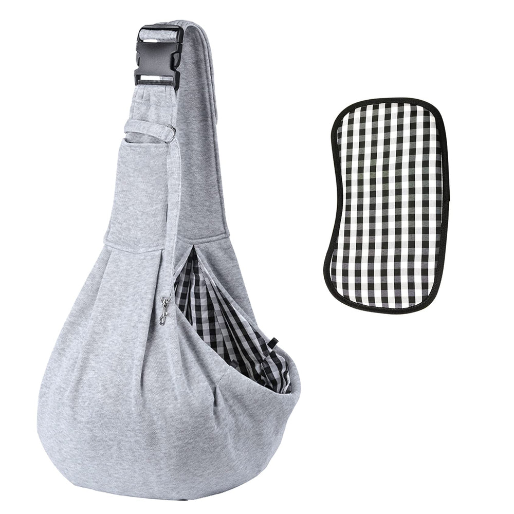 Kanemc dog sling worn on the shoulder for hands-free city outings and comfort.