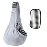 Kanemc dog sling worn on the shoulder for hands-free city outings and comfort.