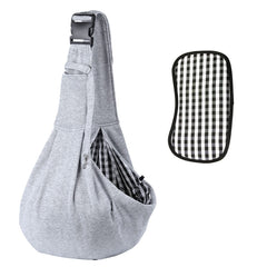 Kanemc dog sling worn on the shoulder for hands-free city outings and comfort.