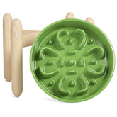 LE TAUCI ceramic slow feeder bowl on a wooden stand promotes paced meals.