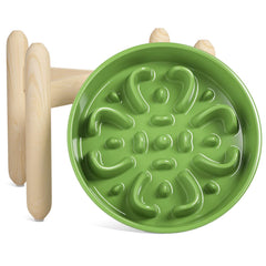 LE TAUCI ceramic slow feeder bowl on a wooden stand promotes paced meals.
