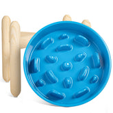 LE TAUCI ceramic slow-feeder on an elevated wooden stand in blue promotes slower meals.