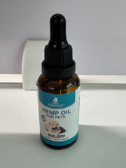 MaxHemp pet oil dropper applying a small dose to a paw for easy dosing.