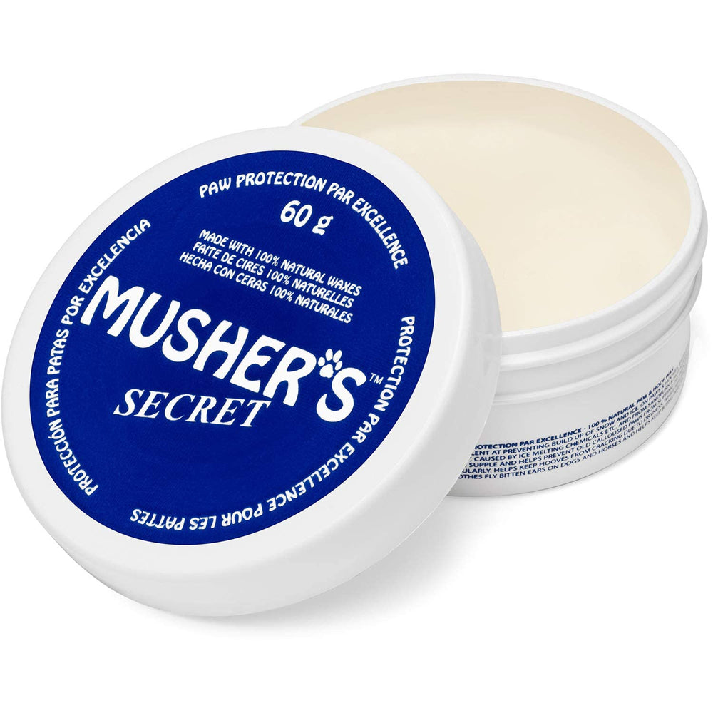 Musher's Secret dog paw wax 60g package shows natural barrier protection for dry paws.