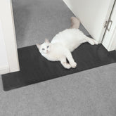 Oroonoko doorway carpet protector roll covering a doorway for pet protection and easy installation.