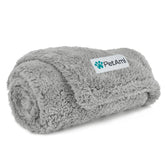 PetAmi fluffy waterproof dog blanket on a sofa protects furniture from spills.