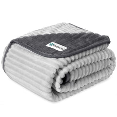 PetAmi waterproof dog blanket on a sofa protects furniture from spills.