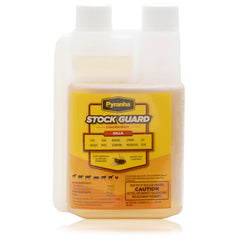 PYRANHA Stock Guard Concentrate bottle pour for flexible pest control in barns.