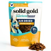 Solid Gold air-dried toppers with real chicken chunks in a bowl for enhanced flavor.