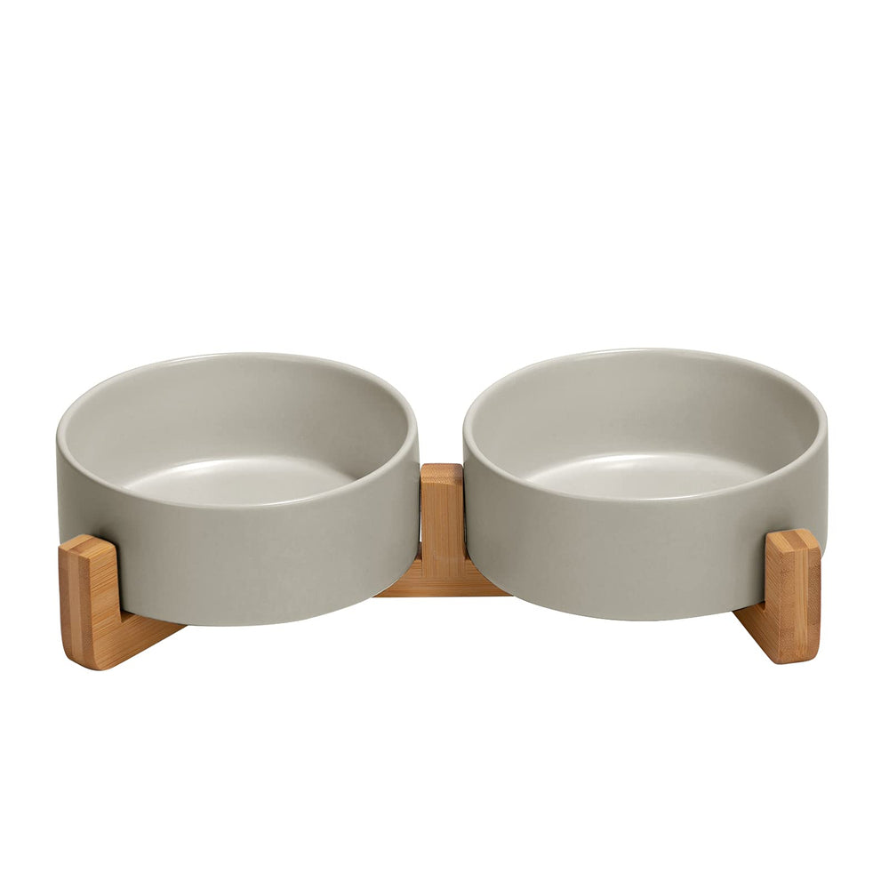 SPUNKYJUNKY ceramic dog bowl with wood stand reduces spills during meals.