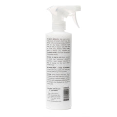 The Stuff dog detangler spray close-up shows mats breaking for smoother brush-through.