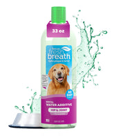 TropiClean Fresh Breath Water Additive bottle being poured into a dog's water bowl