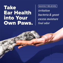 TropiClean HomeVet ear drops being applied to a dog's ear for relief