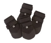 Ultra Paws Rugged dog boots on a paw resting on pavement provide heat protection and grip.