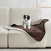 Yaning waterproof blanket on bed provides spill protection and cozy warmth.