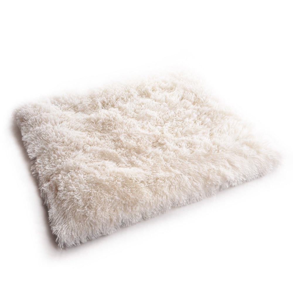 4CLAWS furry pet bed mat on a modern sofa showcases stylish, minimal design