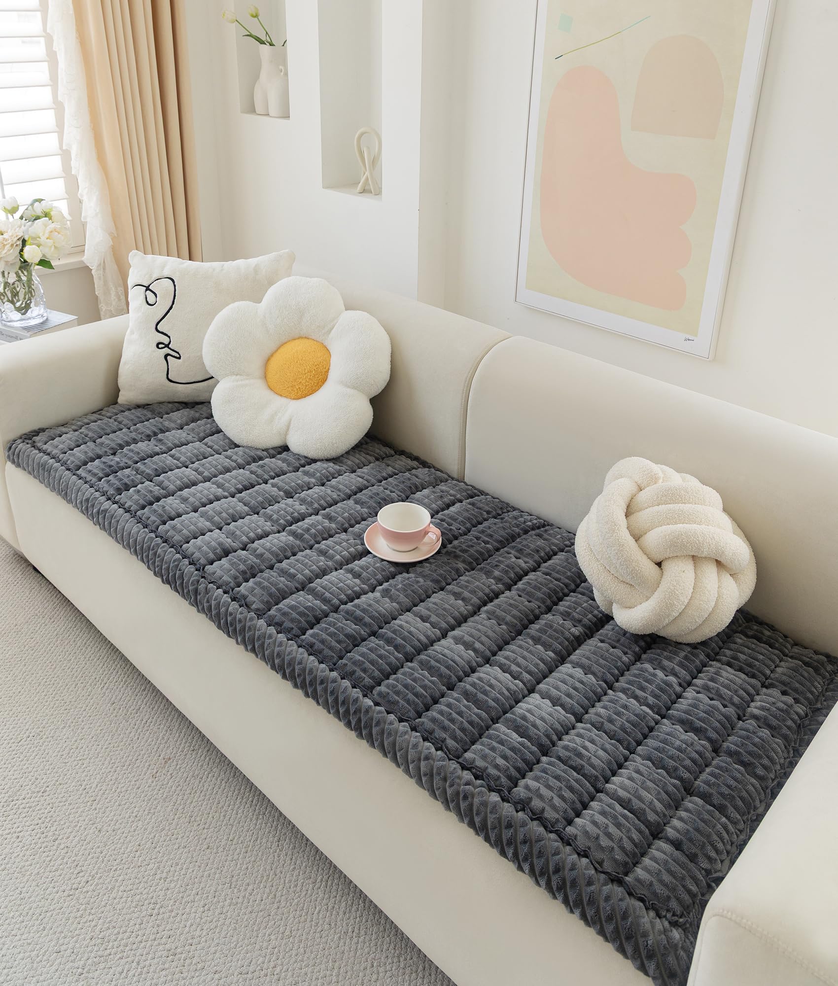 AEEISHOMEREFORM couch cover in dark grey on a three-seat sofa protects and adds cozy softness.