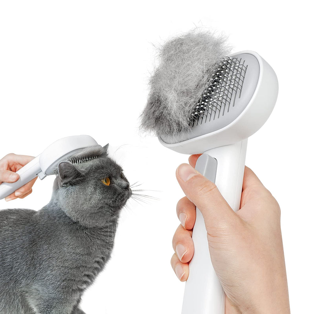 Aumuca cat brush release button closeup shows quick hair release after grooming.
