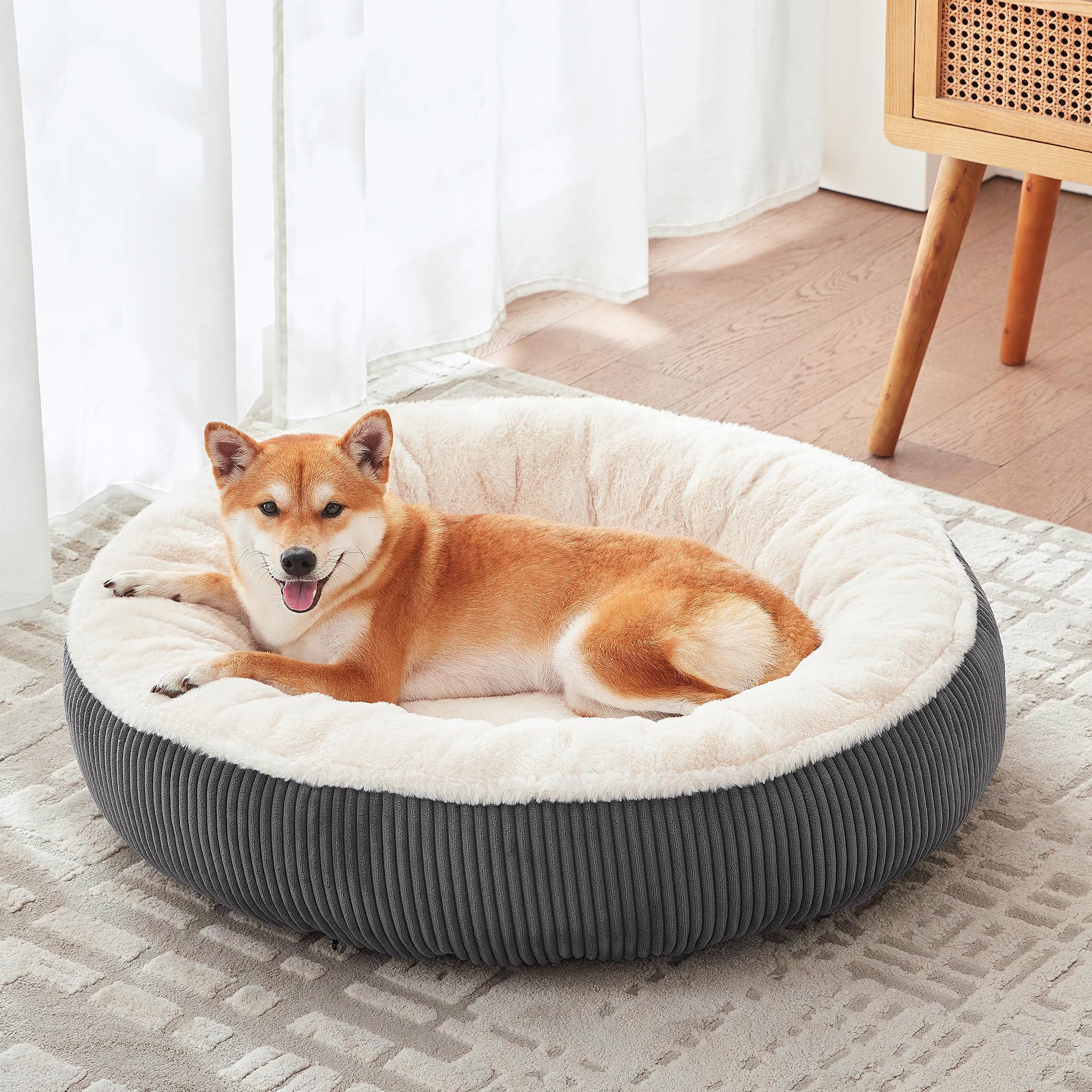 BedStill donut dog bed dark grey side view highlights calming raised rim support
