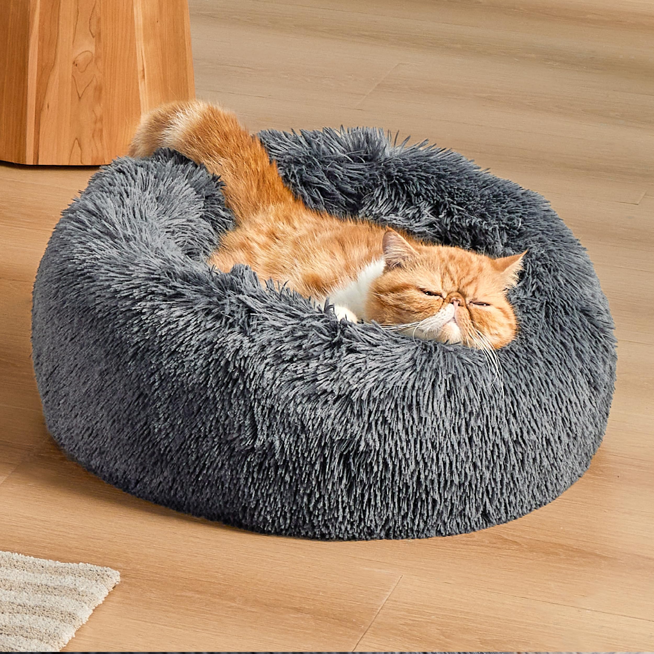 Bedsure calming cat bed donut design supports head and neck for cozy naps.