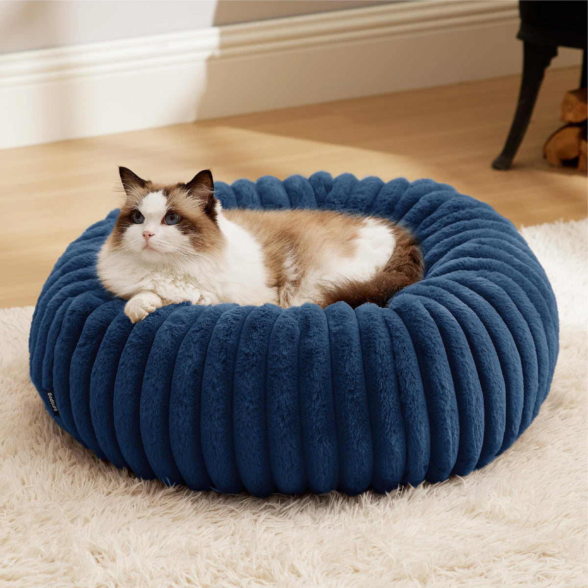 Bedsure donut bed night blue 20x20x6 provides cozy support for small pets seeking rest.