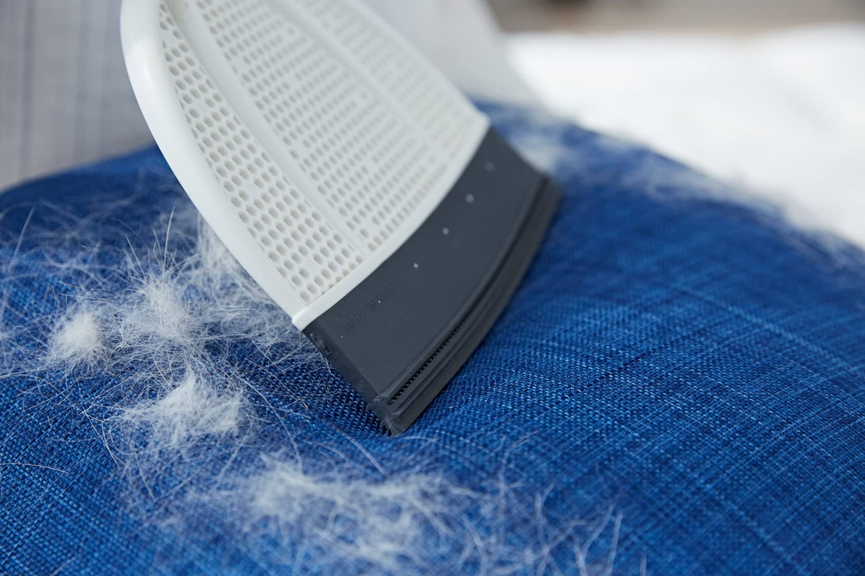 Broombi works on fabrics and furniture to remove lint from pillows bedding and more