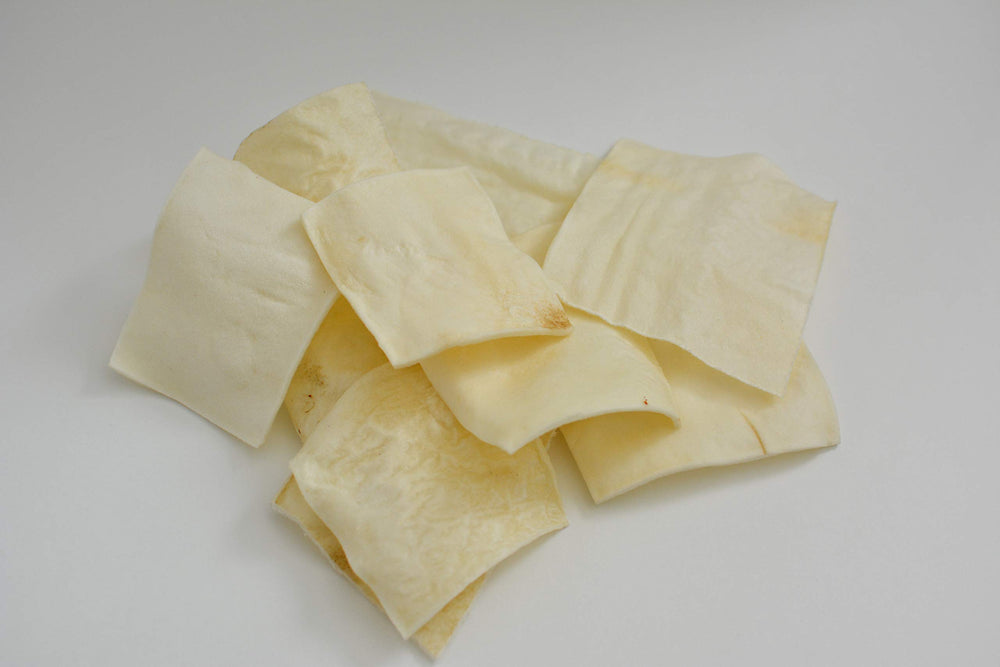 Canine Butcher Shop thick-cut rawhide image showcases chew time extension and reduced breakage.