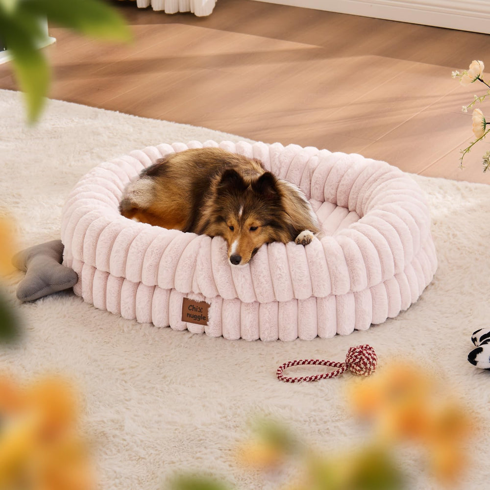 ChiXnuggle dog bed pink striped front view highlighting plush, soothing comfort.