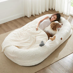 ChiXnuggle human dog bed ivory close-up shows plush faux fur for luxurious lounging.