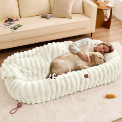 ChiXnuggle Human Dog Bed features striped fabric for cozy lounging at home.