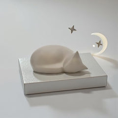 Comemori sleeping cat urn side view in light taupe ideal for serene memory corner