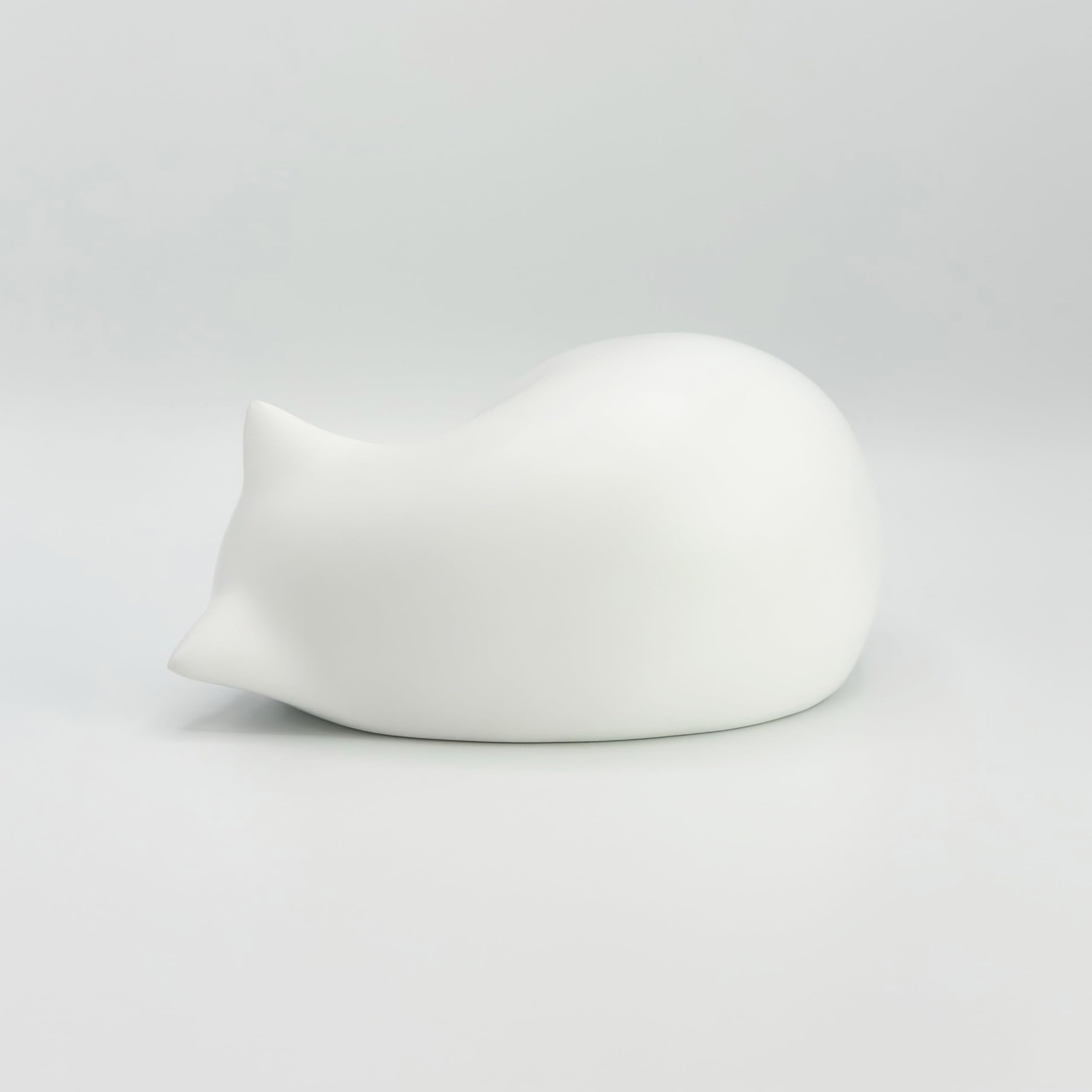 Comemori Sleeping Cat Urn White display-ready on a shelf for respectful memory.