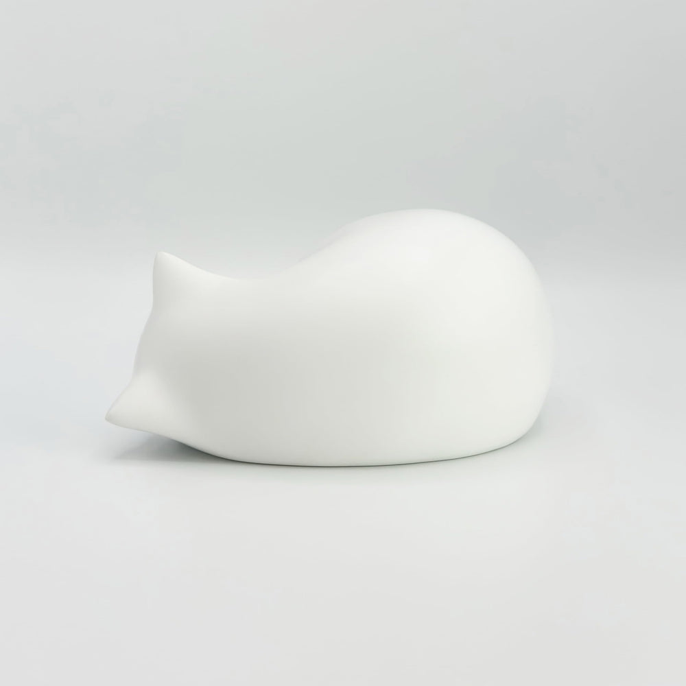 Comemori Sleeping Cat Urn White display-ready on a shelf for respectful memory.