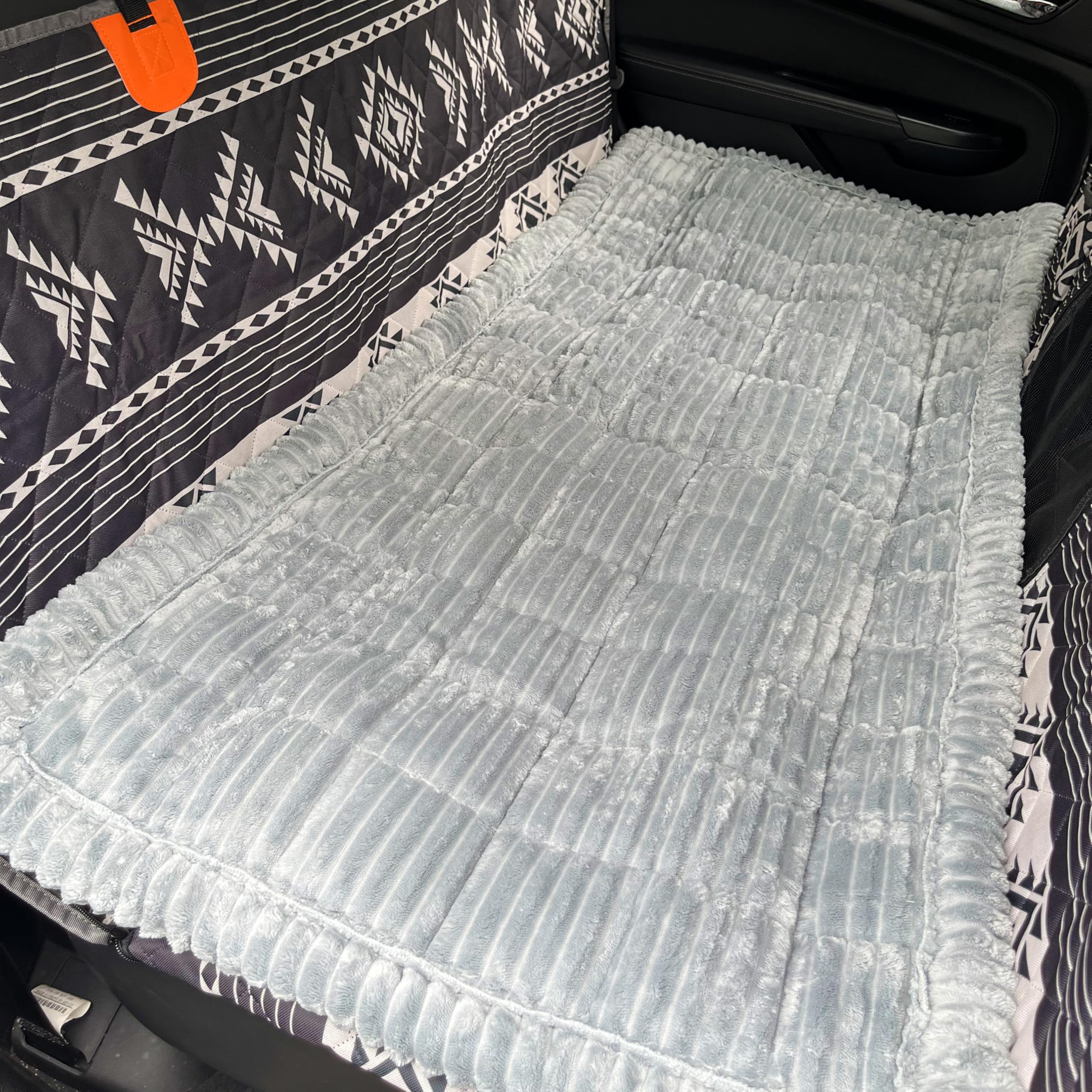Cshionary dog bed for car with soft fabric enhances cozy in-vehicle rest.