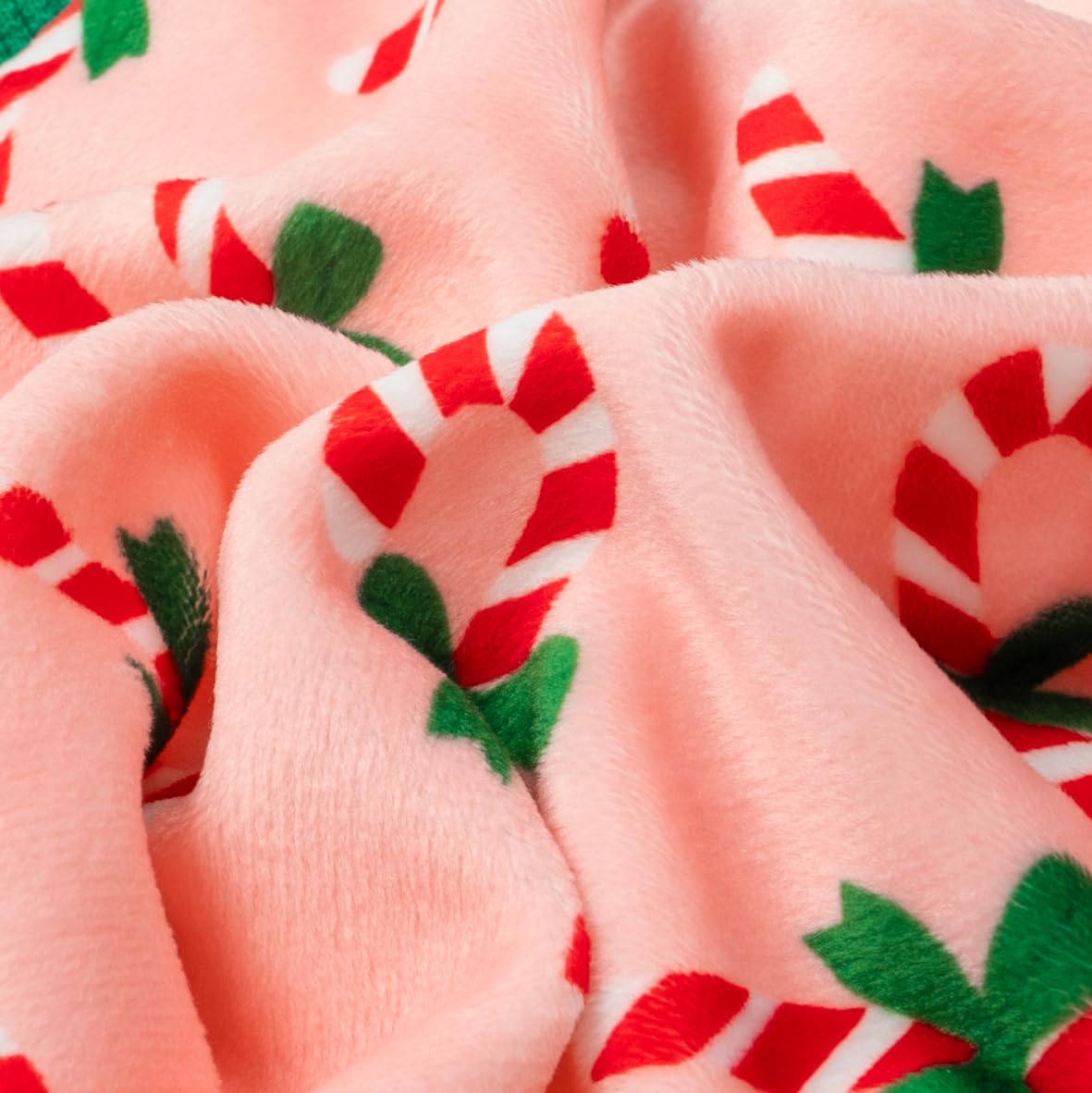 Fitwarm Candy Cane Dog Pajamas fabric closeup reveals breathable stretch material.