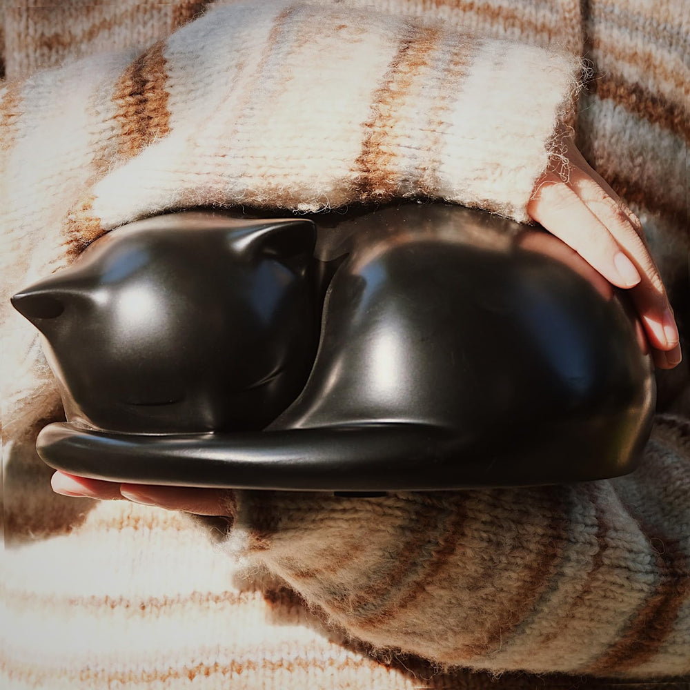 FUFYUKEY cat urn side view showing tranquil resting pose for display.